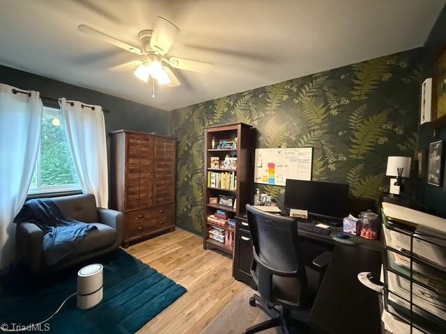 7098 E Fork Rd, High Point, NC 27265 - home office with wallpapered walls, light wood-style flooring, and ceiling fan