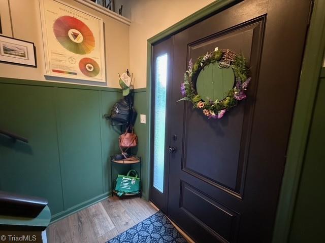 7098 E Fork Rd, High Point, NC 27265 - foyer entrance with wood finished floors, wainscoting, and a decorative wall
