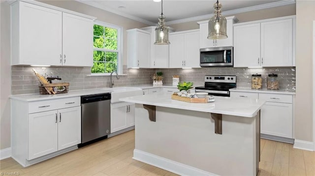 kitchen featuring backsplash, stainless steel appliances, and white cabinetry