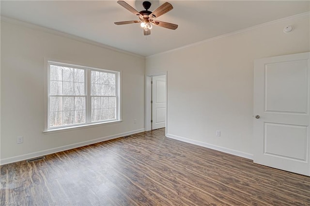 unfurnished room with ceiling fan, ornamental molding, visible vents, wood finished floors, and baseboards