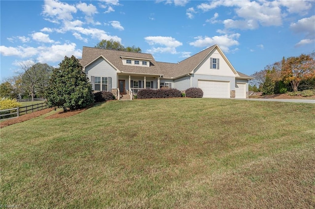 view of front facade featuring covered porch, a garage, and a front yard