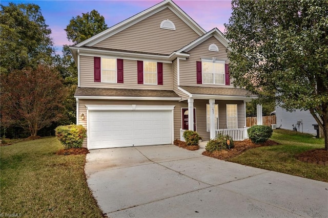 front facade with a yard, a garage, and a porch