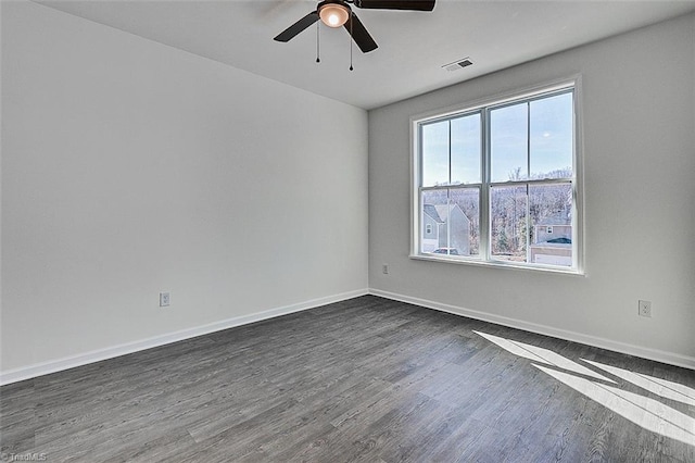 spare room with ceiling fan and dark hardwood / wood-style flooring