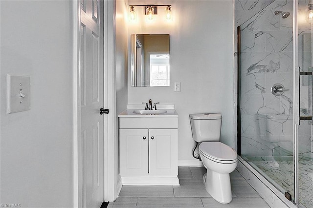 bathroom featuring toilet, vanity, and a shower with door