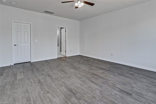 unfurnished room with ceiling fan and dark wood-type flooring