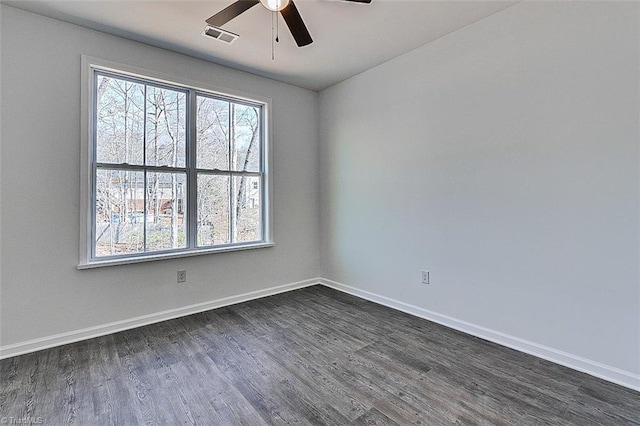 empty room featuring dark hardwood / wood-style flooring and ceiling fan