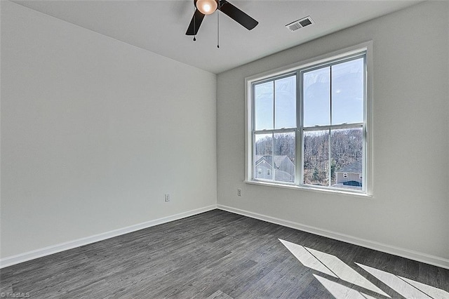 empty room featuring dark hardwood / wood-style flooring and ceiling fan