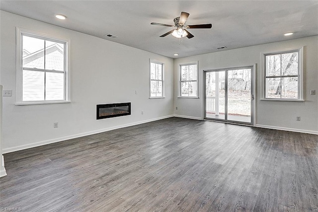 unfurnished living room featuring dark hardwood / wood-style floors and ceiling fan