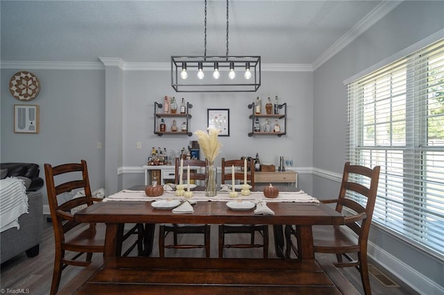 dining space featuring crown molding and dark hardwood / wood-style floors