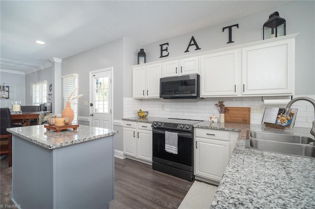 kitchen with dark hardwood / wood-style flooring, white cabinets, sink, and electric range