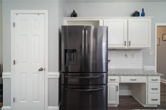 kitchen featuring tasteful backsplash, dark wood-type flooring, stainless steel fridge with ice dispenser, white cabinetry, and light stone countertops