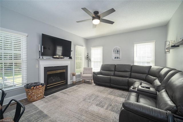 living room featuring ceiling fan, hardwood / wood-style flooring, and a healthy amount of sunlight