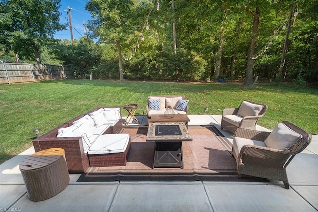 view of patio with an outdoor living space with a fire pit