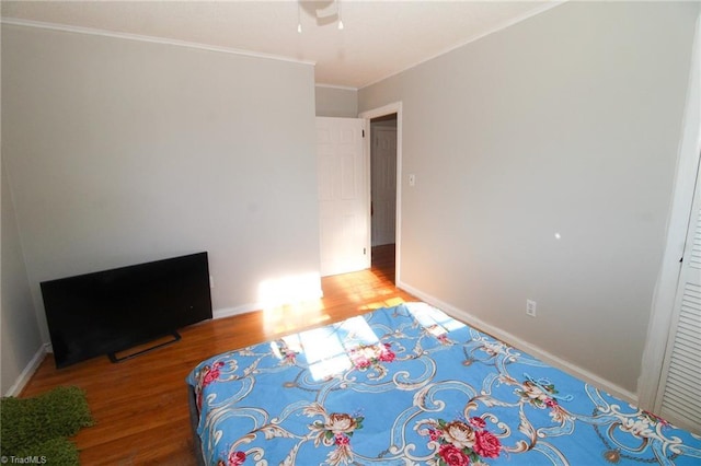 unfurnished bedroom with wood-type flooring and ornamental molding