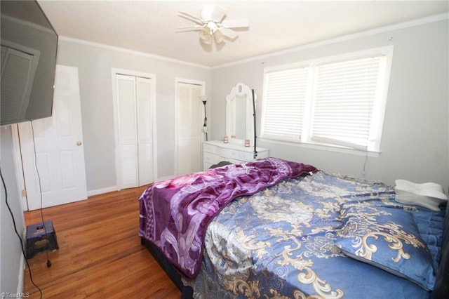 bedroom with dark hardwood / wood-style flooring, ceiling fan, and crown molding