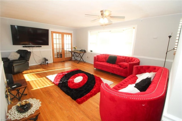 living room with hardwood / wood-style flooring, ceiling fan, and french doors