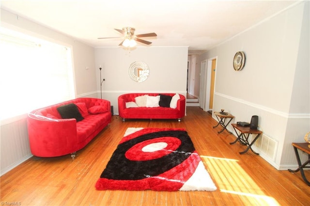 living room featuring wood-type flooring and ceiling fan