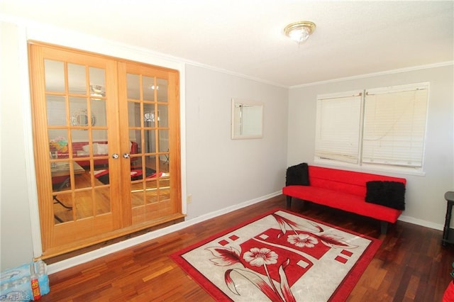 living area featuring dark hardwood / wood-style flooring and ornamental molding