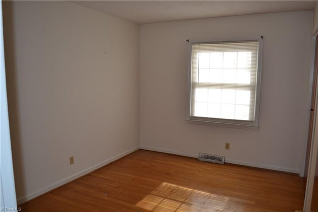 unfurnished room with light wood-type flooring