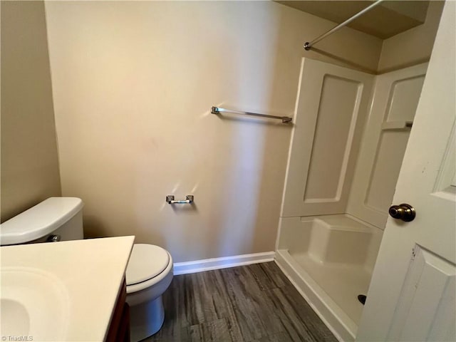 3638 Morris Farm Dr, Greensboro, NC 27409 - bathroom featuring a shower, toilet, wood finished floors, baseboards, and vanity