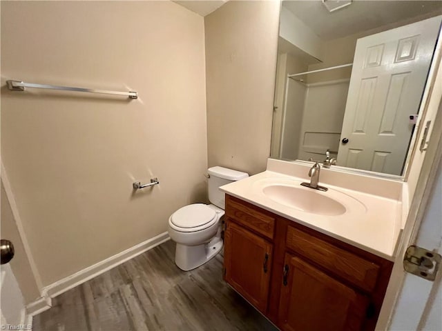 3638 Morris Farm Dr, Greensboro, NC 27409 - full bath featuring a shower, toilet, vanity, wood finished floors, and baseboards