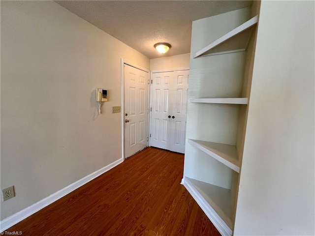 3638 Morris Farm Dr, Greensboro, NC 27409 - hallway featuring wood finished floors, a textured ceiling, and baseboards