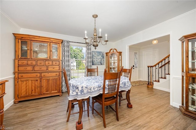 1101 Shalimar Ct, High Point, NC 27262 - dining room with a chandelier, light wood finished floors, ornamental molding, stairs, and baseboards