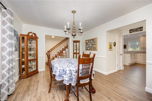 1101 Shalimar Ct, High Point, NC 27262 - dining room featuring a chandelier, light wood-style flooring, crown molding, stairs, and baseboards