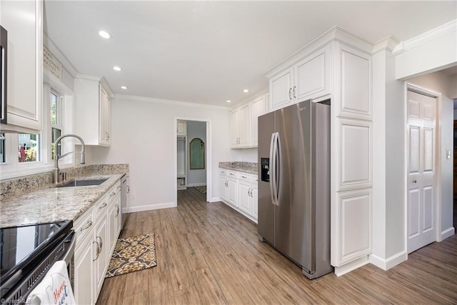 1101 Shalimar Ct, High Point, NC 27262 - kitchen with stainless steel appliances, a sink, white cabinets, baseboards, and ornamental molding