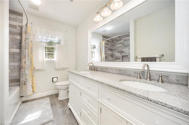 1101 Shalimar Ct, High Point, NC 27262 - bathroom with double vanity, toilet, shower / bath combo, wood finished floors, and baseboards