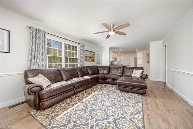1101 Shalimar Ct, High Point, NC 27262 - living area with a ceiling fan, light wood-style floors, baseboards, and ornamental molding