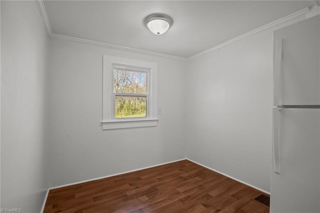 unfurnished room with dark wood-style floors and ornamental molding