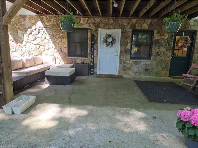866 Trinity Church Rd, Tobaccoville, NC 27050 - doorway to property featuring stone siding, outdoor lounge area, and a patio