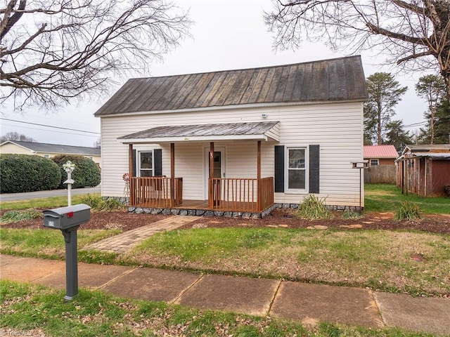 view of front of house with a porch and a front yard