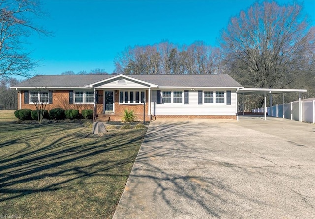 ranch-style house featuring a carport and a front lawn