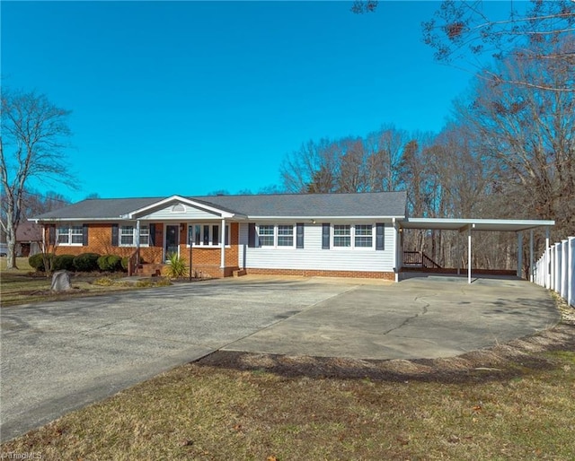 ranch-style home featuring a carport and covered porch