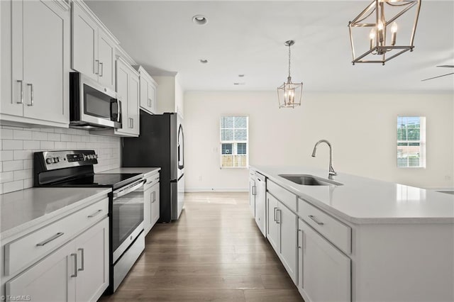 2109 Freeman St, Winston-Salem, NC 27127 - kitchen with stainless steel appliances, a chandelier, tasteful backsplash, wood finished floors, and light countertops