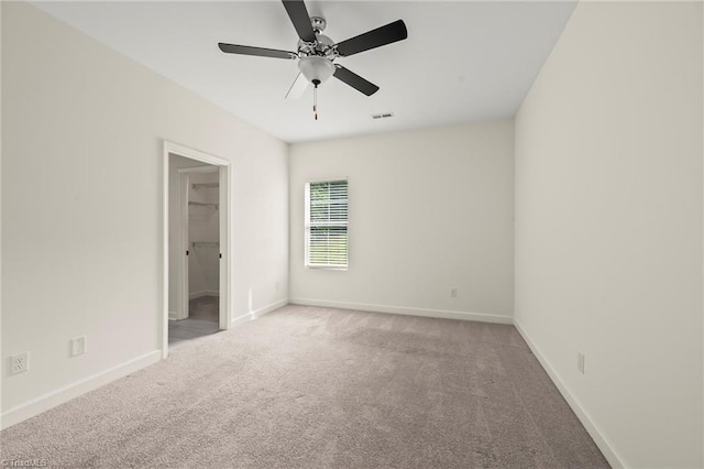 2109 Freeman St, Winston-Salem, NC 27127 - unfurnished bedroom featuring carpet, a spacious closet, and a ceiling fan