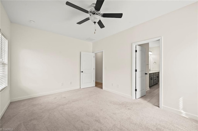 2109 Freeman St, Winston-Salem, NC 27127 - unfurnished bedroom featuring light colored carpet, ensuite bath, and ceiling fan