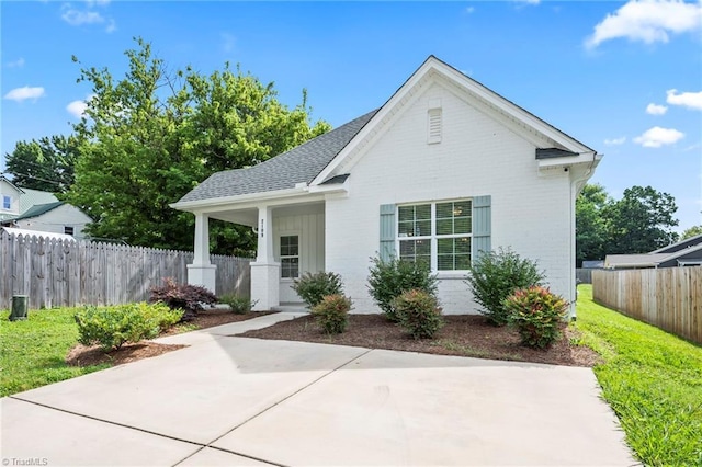 2109 Freeman St, Winston-Salem, NC 27127 - view of front of home featuring brick siding, a patio area, and a shingled roof