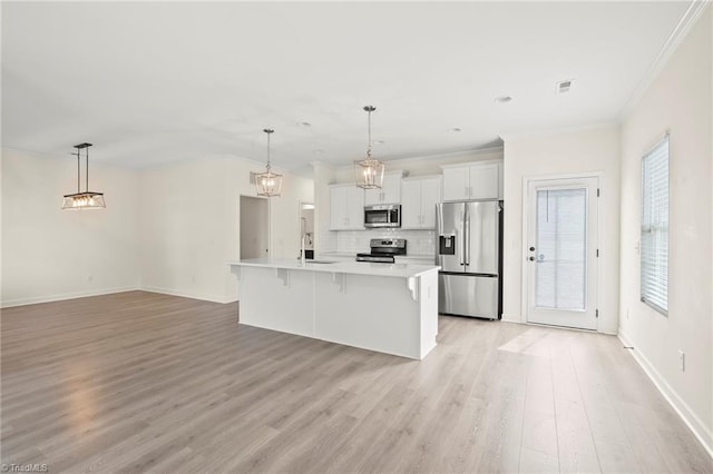 2109 Freeman St, Winston-Salem, NC 27127 - kitchen featuring stainless steel appliances, ornamental molding, a breakfast bar, light countertops, and light wood-style flooring