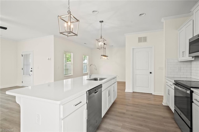 2109 Freeman St, Winston-Salem, NC 27127 - kitchen with stainless steel appliances, crown molding, light countertops, tasteful backsplash, and light wood-style flooring
