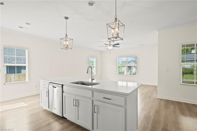 2109 Freeman St, Winston-Salem, NC 27127 - kitchen featuring stainless steel dishwasher, a chandelier, light countertops, light wood-style floors, and decorative light fixtures