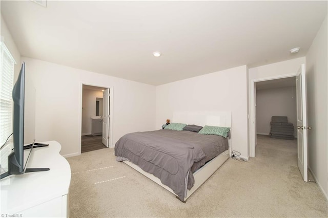 bedroom featuring light colored carpet and baseboards