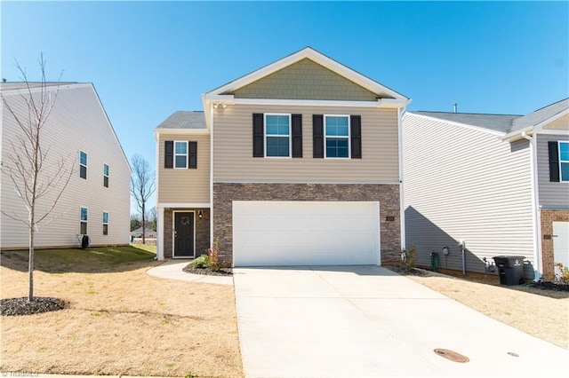 view of front of home featuring stone siding, driveway, and a garage