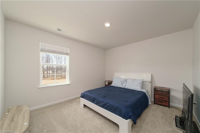 carpeted bedroom featuring visible vents and baseboards