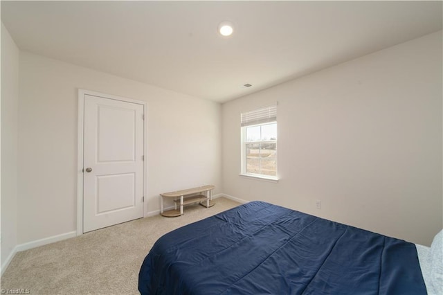 bedroom with baseboards and carpet