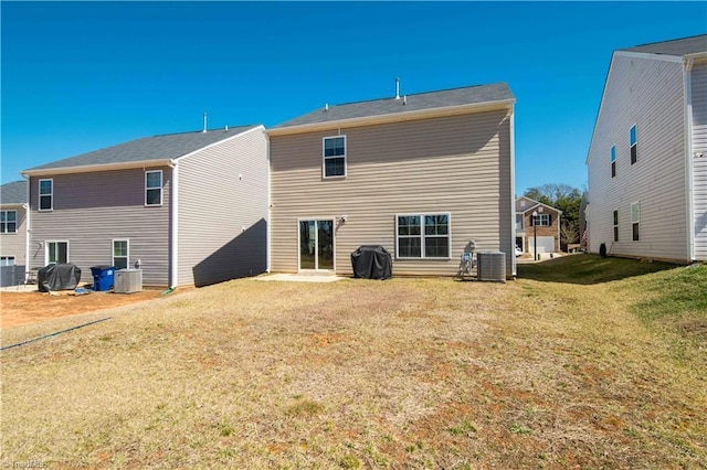 back of house with a yard and cooling unit