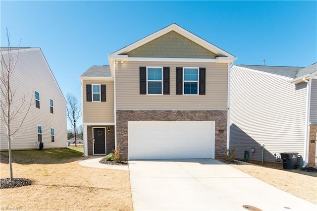 view of front of house featuring an attached garage, concrete driveway, and a front lawn