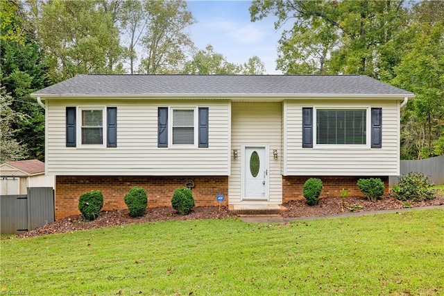 raised ranch featuring a front lawn